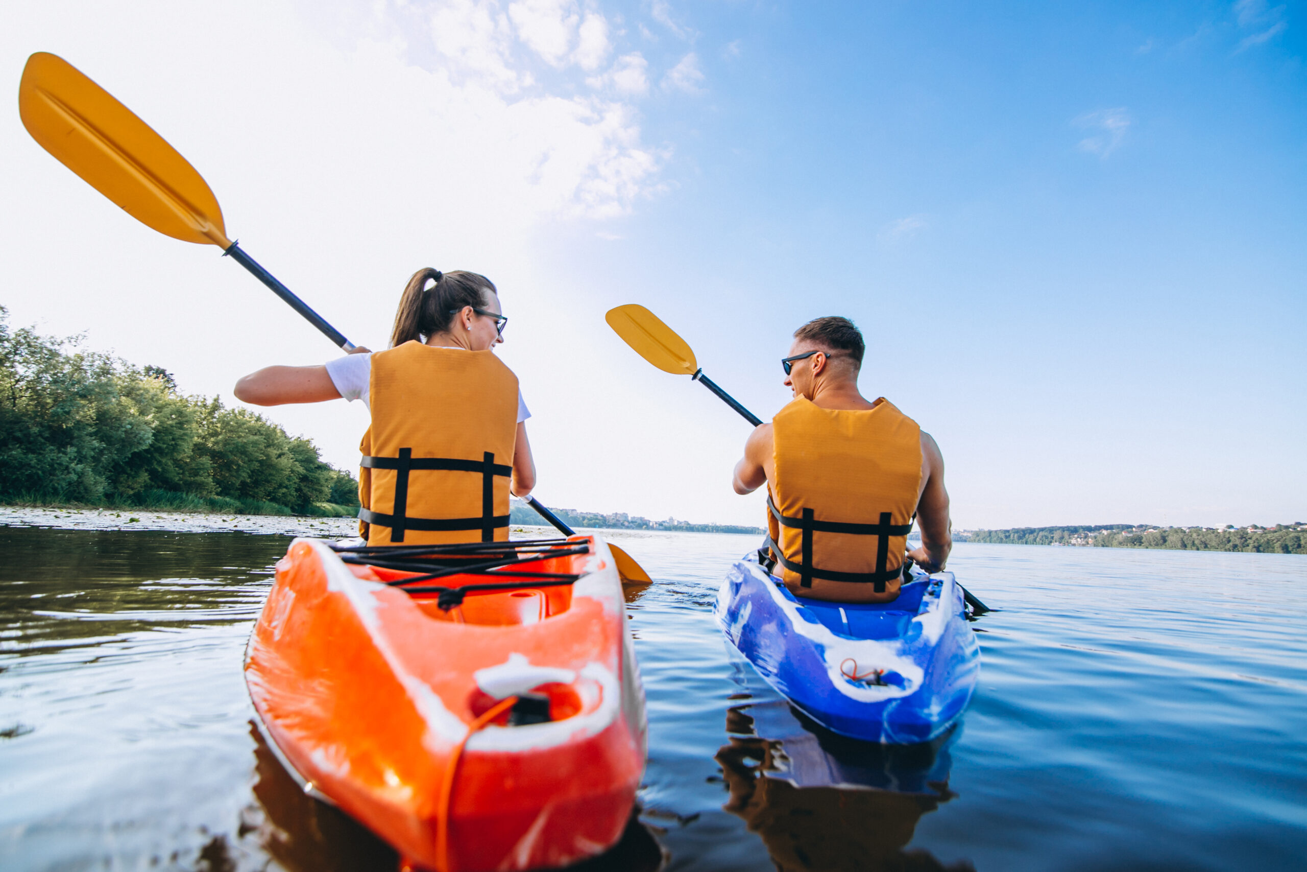 Couple together kayaking on the river Couple together kayaking on the river